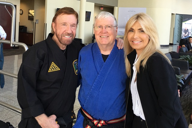 Chuck and Gina Norris pose with Keith Yates before the service for Jhoon Rhee.